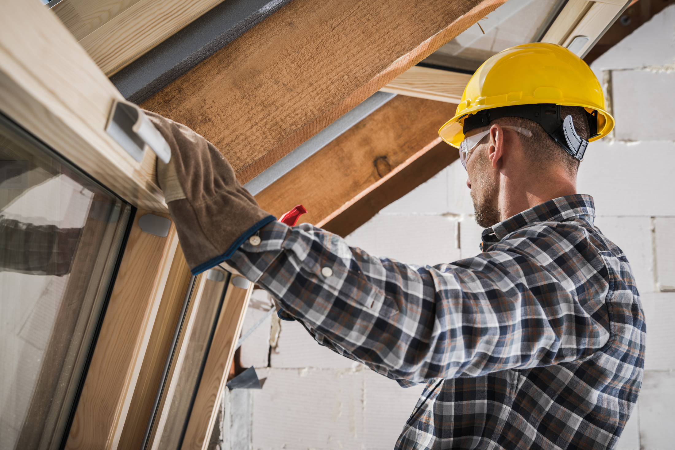 Wooden Roof Windows Installation during House Construction